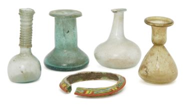 Four small Roman glass vessels and a bangle circa 2nd-4th century AD. Including a pale blue sph...