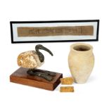 An Egyptian bronze and gesso-painted wood Ibis, an ink inscribed textile fragment, stone pot and ...