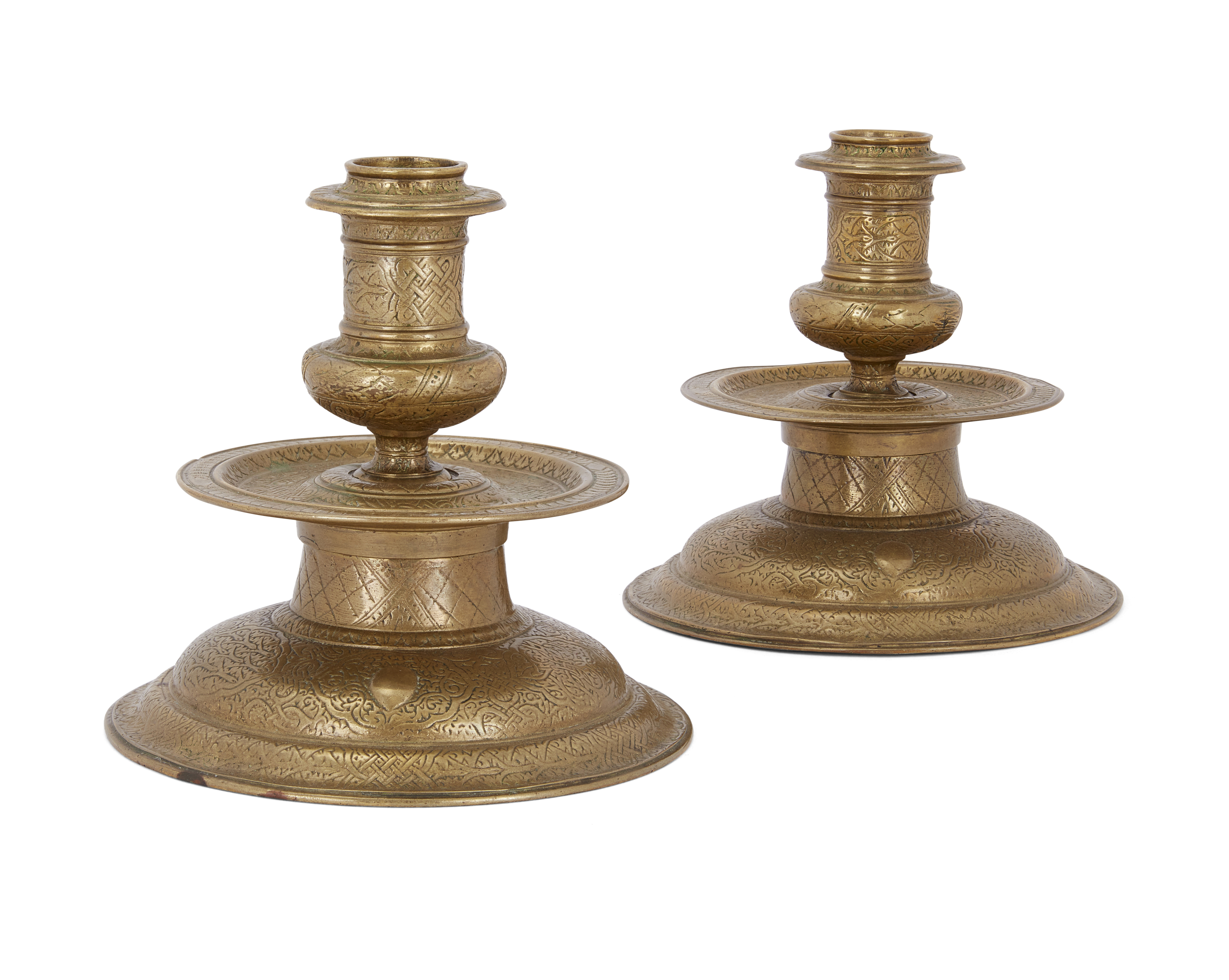 Two Veneto-Saracenic candlesticks, late 19th-early 20th century, Of typical form, the flanged t...