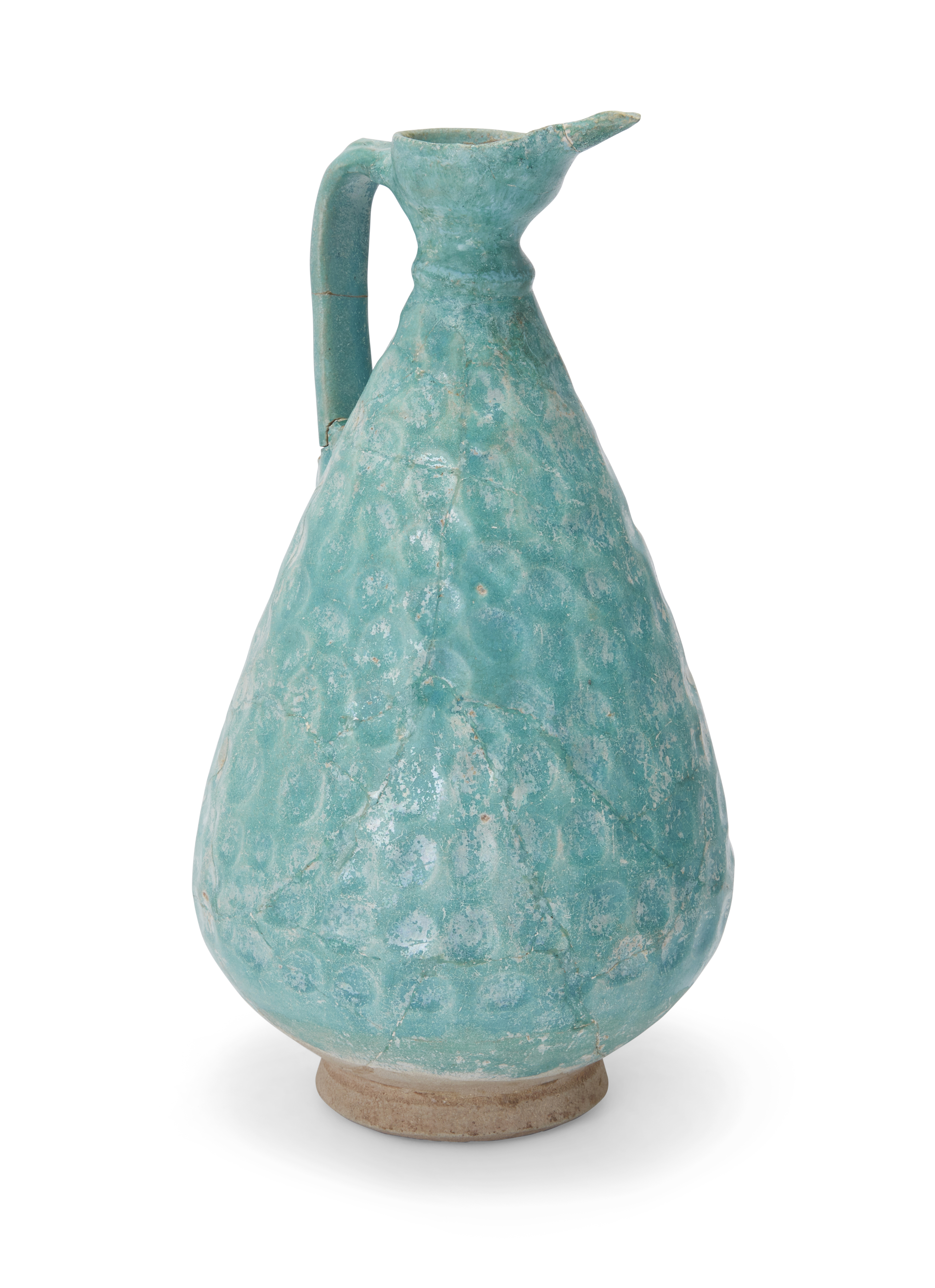 A turquoise blue-glazed pottery footed jug, Kashan, Central Iran, 12th century, of drop-shaped ...