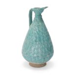 A turquoise blue-glazed pottery footed jug, Kashan, Central Iran, 12th century, of drop-shaped ...