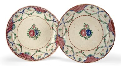 Two Qajar pottery bowls, Iran, 19th century Of shallow form, underglaze decorated in pink, blue...