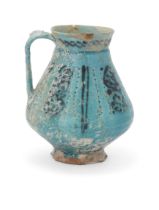 A Kashan turquoise glazed footed pottery jug,   Kashan, central Iran, 12th century, Pyriform, t...