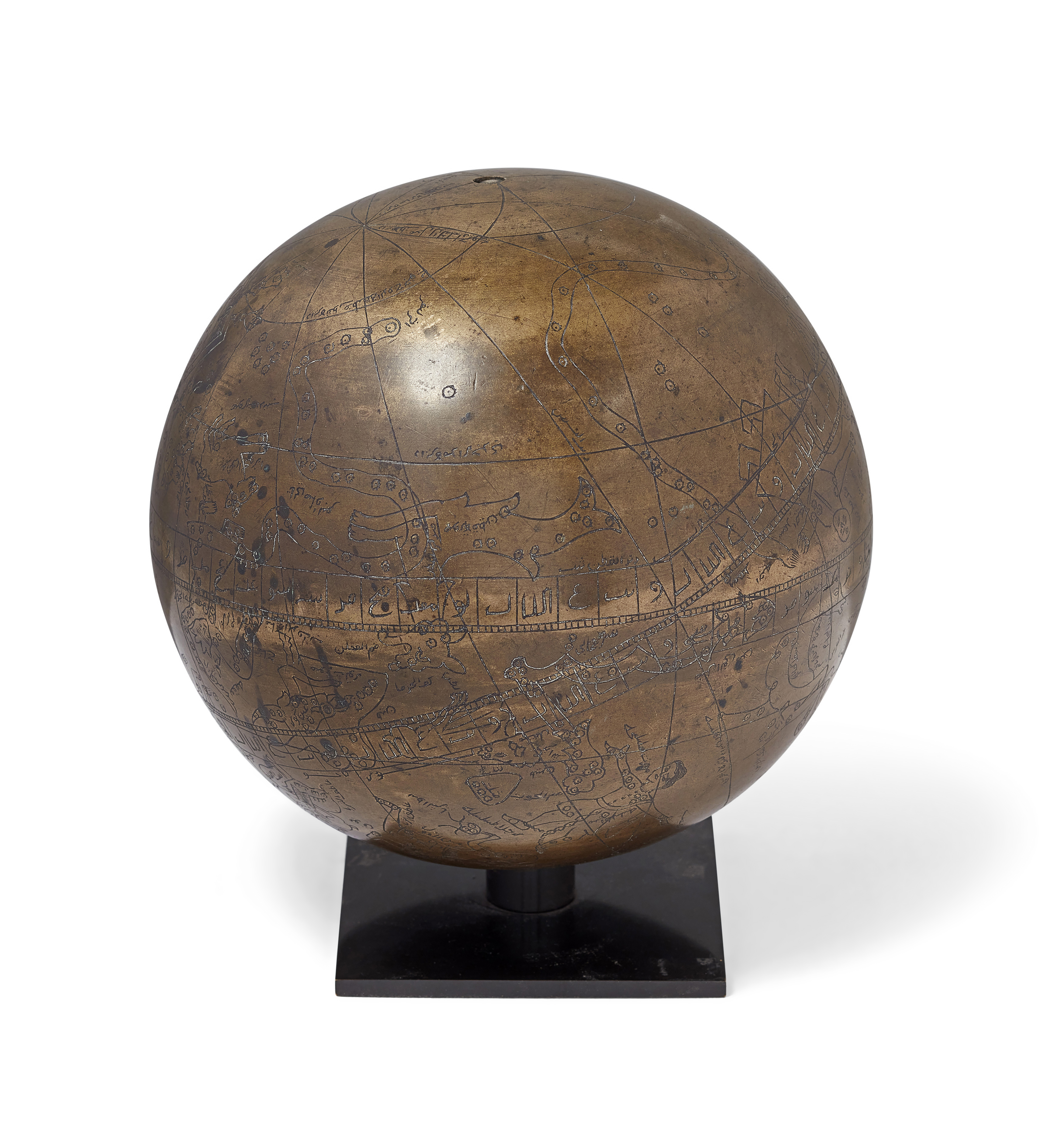 An engraved brass celestial globe, Iran, 20th century, On stand, 23.4cm. diam.