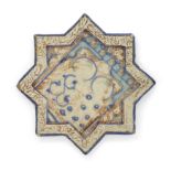 A lustre and cobalt blue figural pottery eight pointed star tile, Kashan, central Iran, 12th cen...