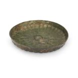 An Achaemenid style copper alloy shallow dish The base with elegant radial decoration, the well ...