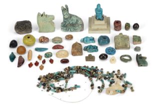 A group of ancient and later faience, hardstone and glass beads and amulets, Including two Egypt...