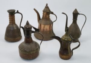 A group of Middle Eastern copper and brass pots and jugs, 20th century, of various shapes and siz...