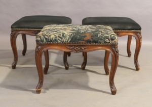 A set of three French walnut stools,19th century, one upholstered with an 18th century floral tap...