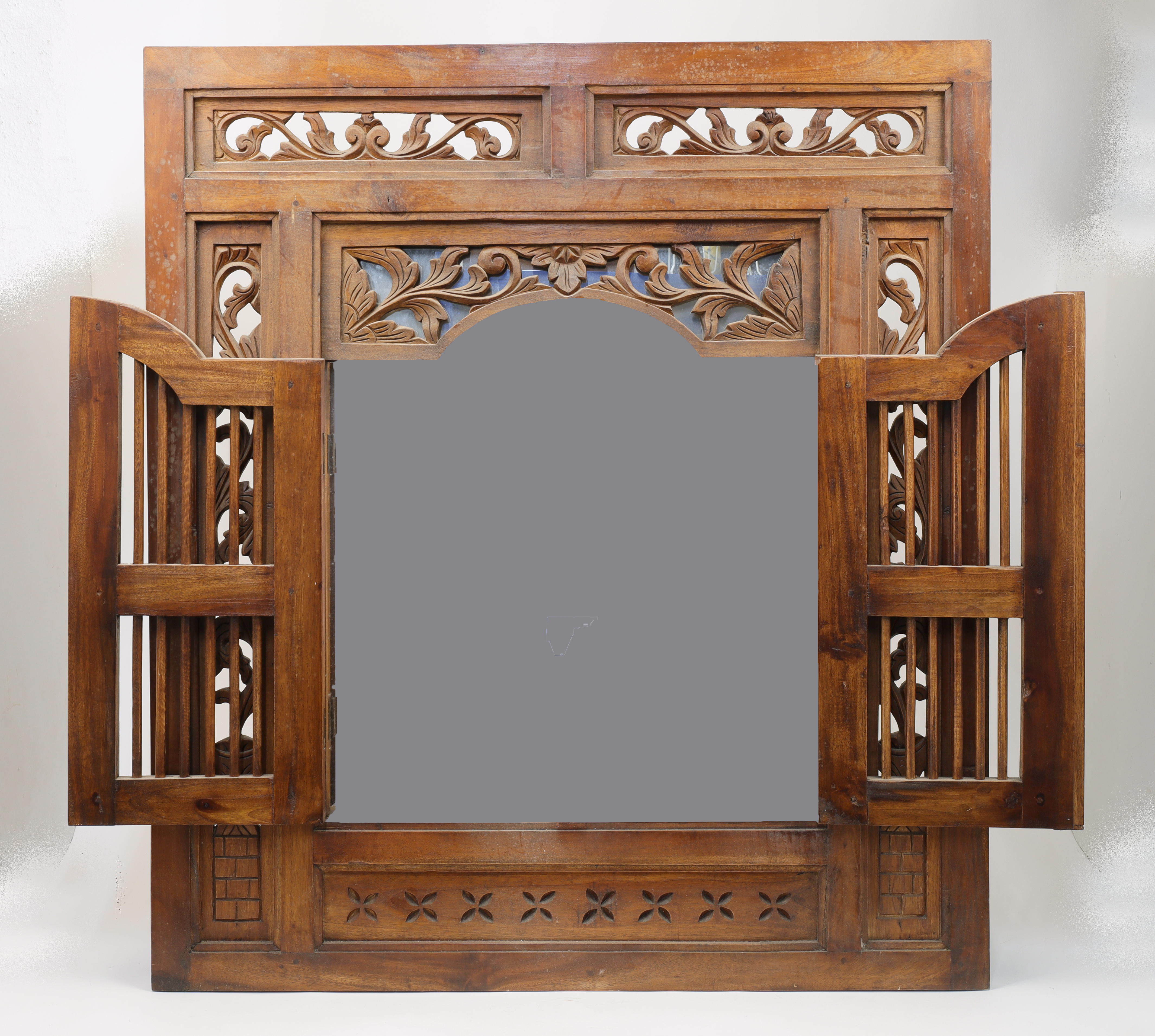 An Indonesian carved teak window shutter converted to a concealed mirror, 20th century, the hinge... - Image 2 of 2