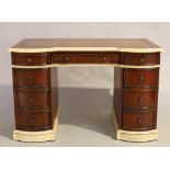 A modern mahogany kneehole desk, George III style, parcel cream painted, tooled leather writing s...