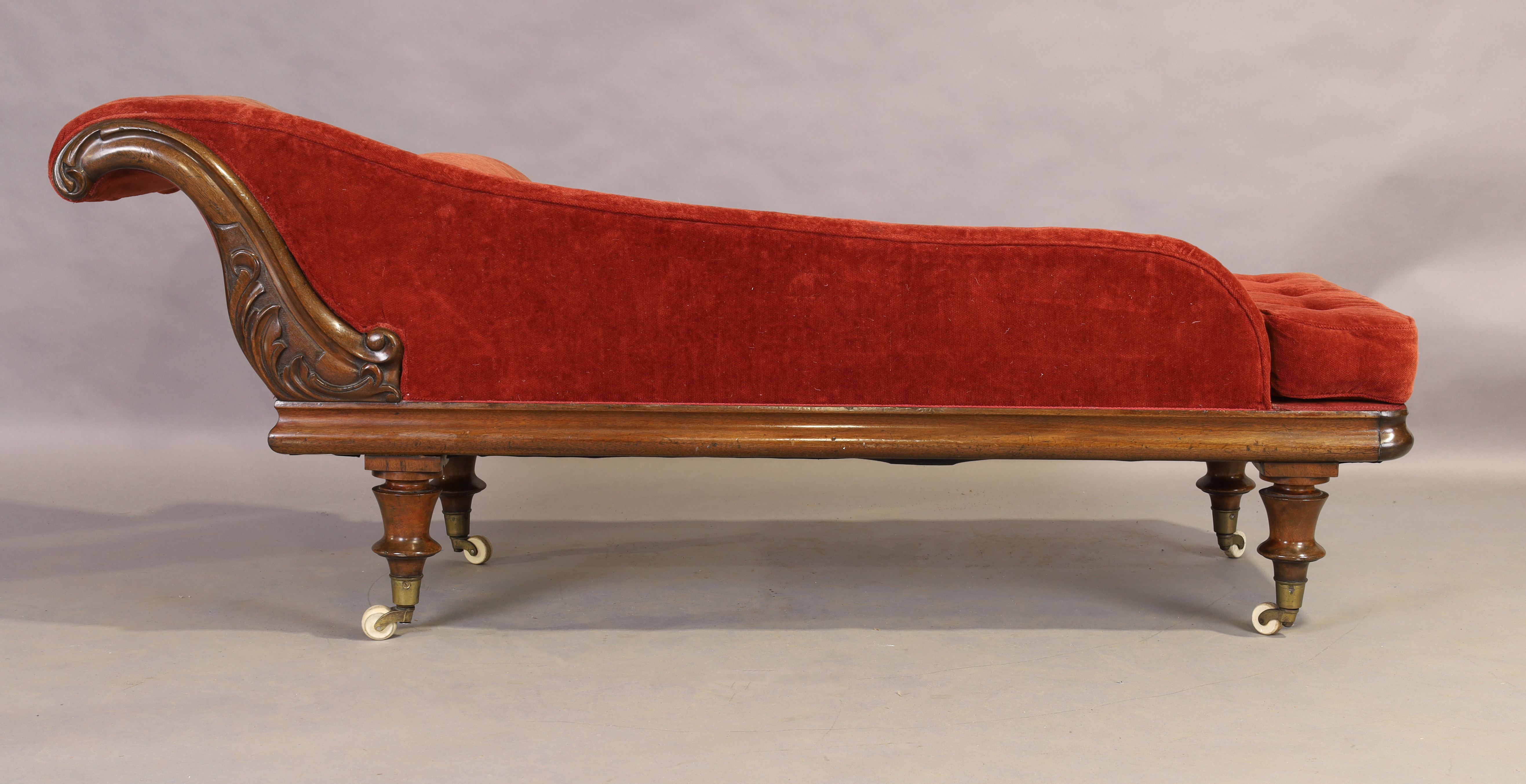 A Victorian mahogany chaise longue, third quarter 19th century, on turned legs to brass caps and ... - Image 2 of 4