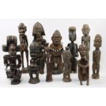 A collection of eleven tribal carved hardwood figures, 20th century, comprising a Fang style figu...