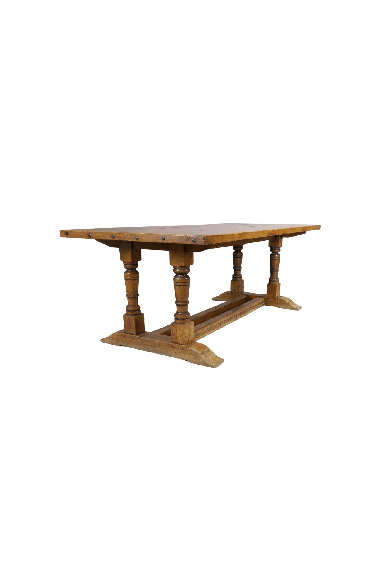 An English oak refectory dining table, first half 20th century, the plank top on turned baluster ...