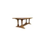 An English oak refectory dining table, first half 20th century, the plank top on turned baluster ...