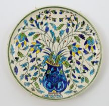 A Kutahya style pottery dish, Qajar Iran, late 19th / early 20th century, polychrome painted to t...