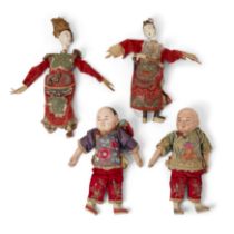 Four Chinese papier mache dolls, Late Qing dynasty, comprising: a pair of boys wearing jacket and...