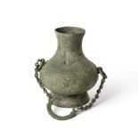 A Chinese archaic bronze vessel, hu, Han dynasty, the compressed body raised on a splayed foot ri...