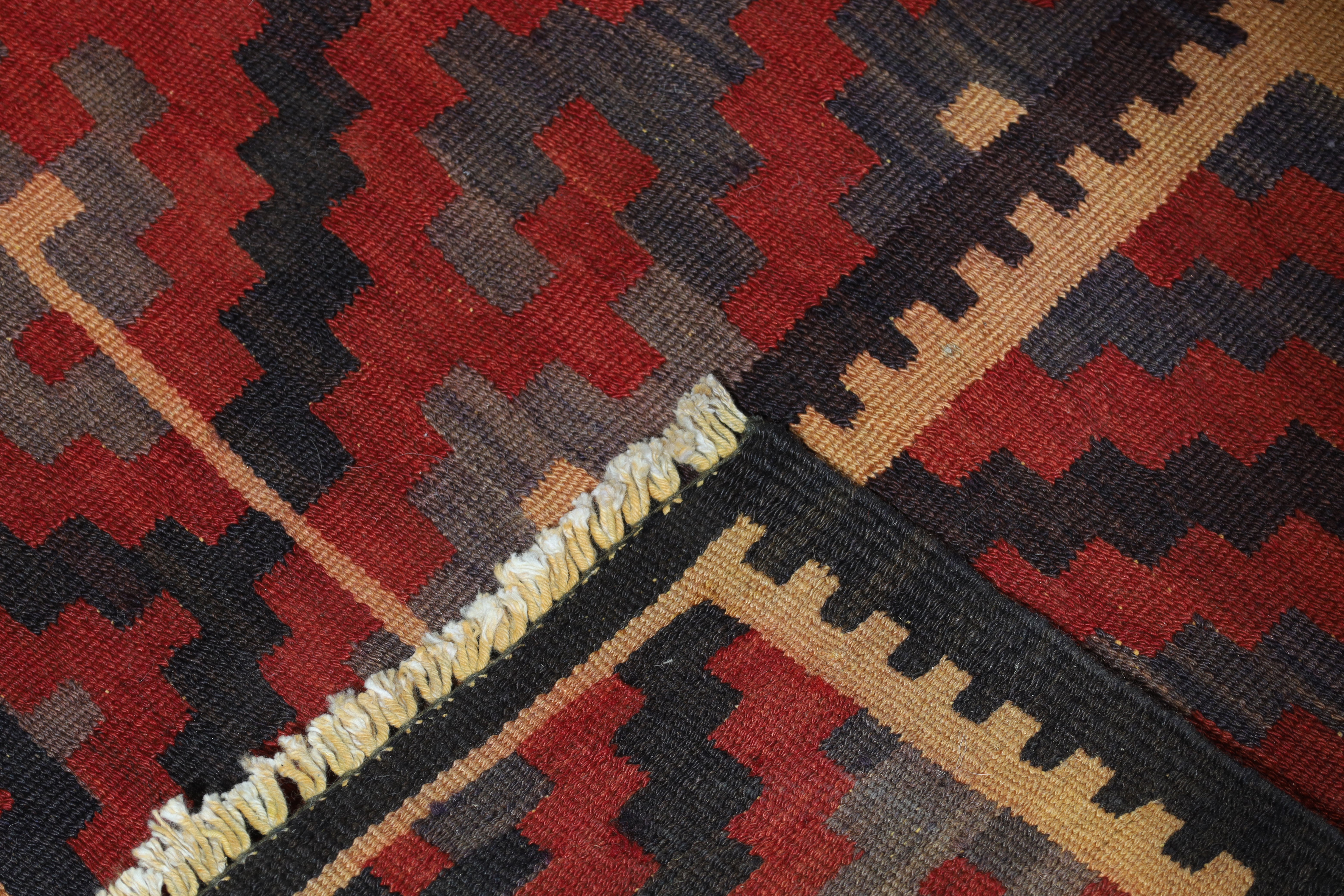 A Persian Qashqai kilim, last quarter 20th century, signed, with geometric design, on a red, blac... - Image 4 of 4