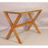 A simulated satinwood X-frame side table, second half 20th century, with glass top, 78cm high, 10...