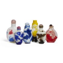 Six Chinese glass overlay snuff bottles, Qing dynasty, 19th century and later, including a blue o...