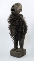 A large Bakongo Nkisi Nkondi carved hardwood fetish figure, Southern Africa, 20th century, with s...