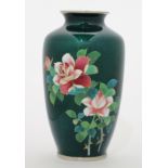 A Japanese enamel baluster vase, 20th century, decorated with sprays of pink roses, on green grou...