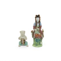 A Chinese famille rose figure of Guanyin and a famille rose boy, Qing dynasty, 18th/19th century,...