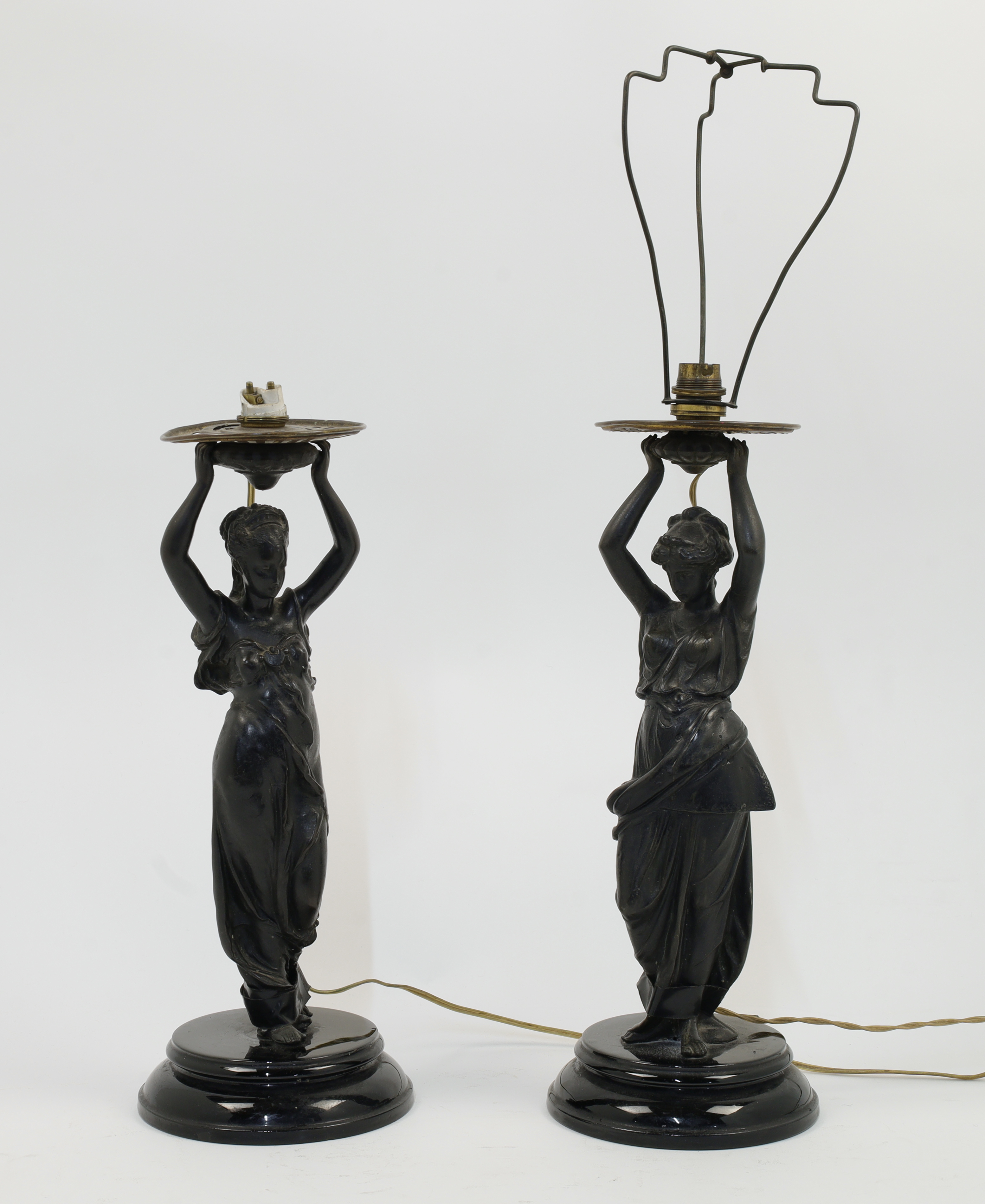 A matched pair of bronzed spelter figural lamps, second half 19th century, each modelled as a cla...