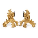 A pair of French ormolu figural chenets, of Louis XV style, 19th century, each modelled with a ch...