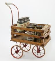 A rare Tri-ang toy milk cart, c.1930s, the wood frame cart with red-painted metal three-wheel sup...