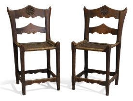 A pair of Russian Arts and Crafts oak side chairs, in the manner of Elena Polenova, first quarter...