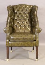 An English mahogany wingback armchair, of George III style, first half 20th century, with green v...