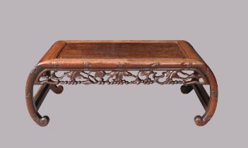 A Chinese hardwood low table, kang, late Qing dynasty, with curved legs and reticulated carved ap...