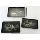 A set of three graduated black lacquer trays, 20th century, each painted with a Chinoiserie lands...