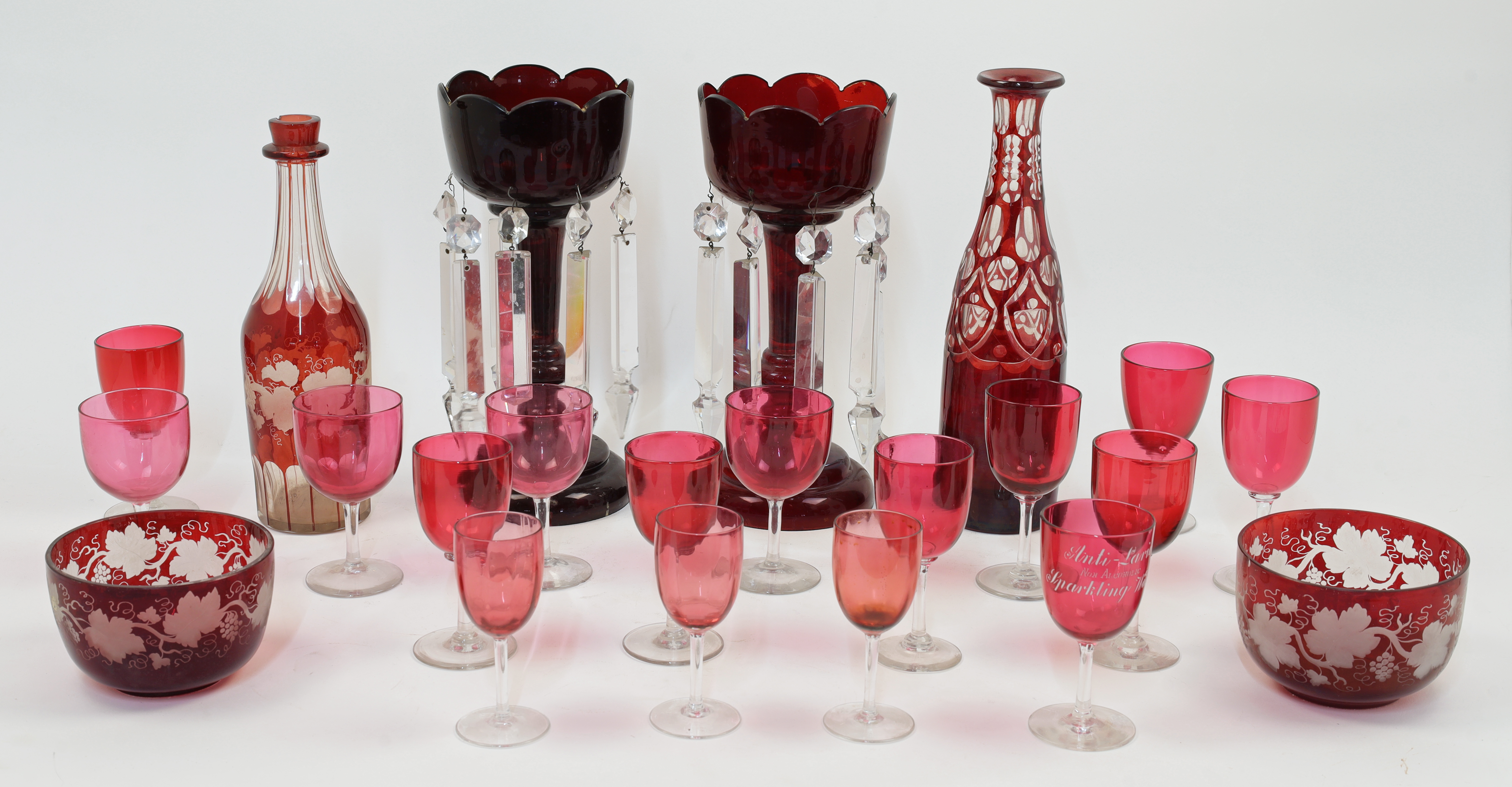 A group of coloured glassware, 19th century, comprising: a pair of ruby glass lustres with clear ...