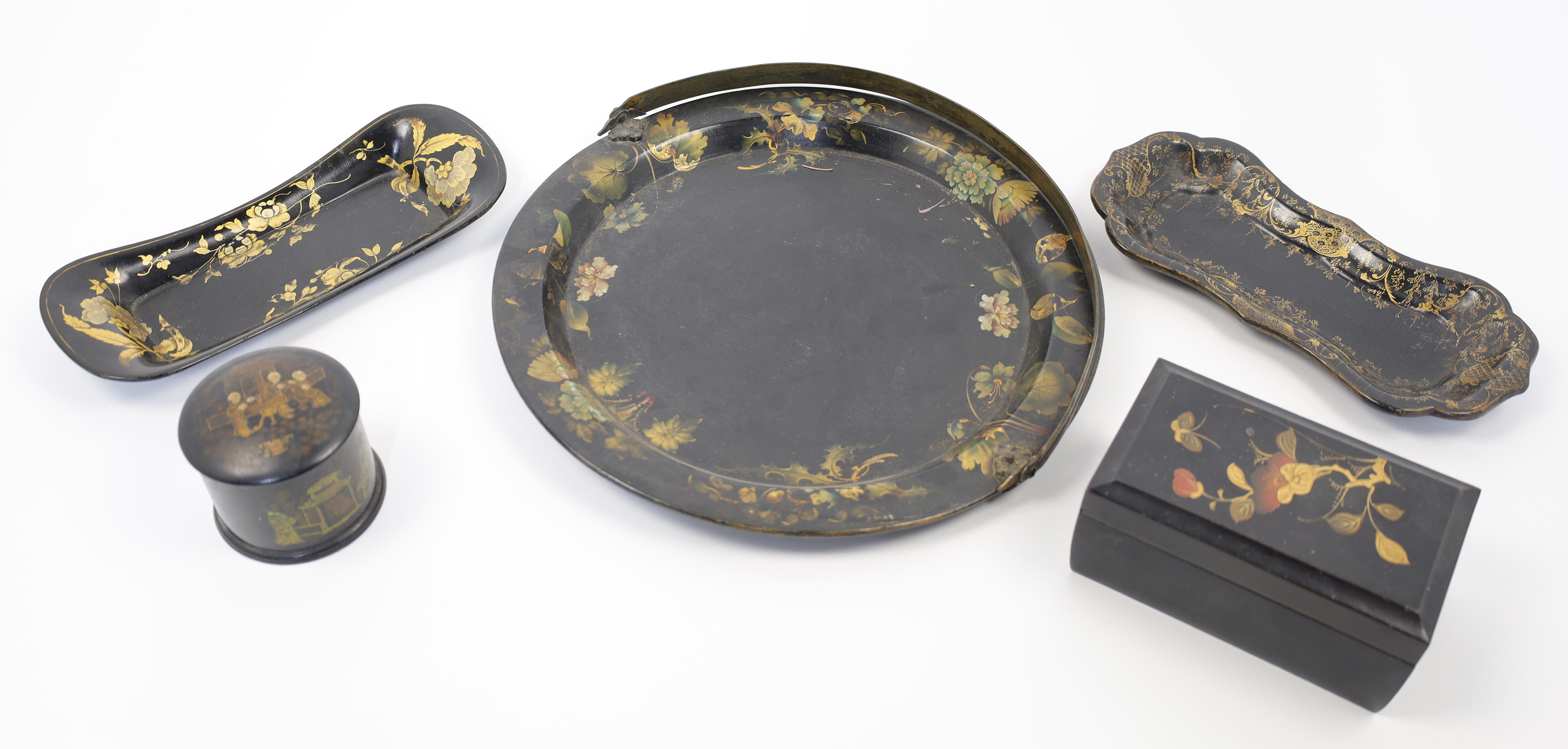 A group of painted black lacquer wares, 19th century, comprising: a Victorian circular tray with ...