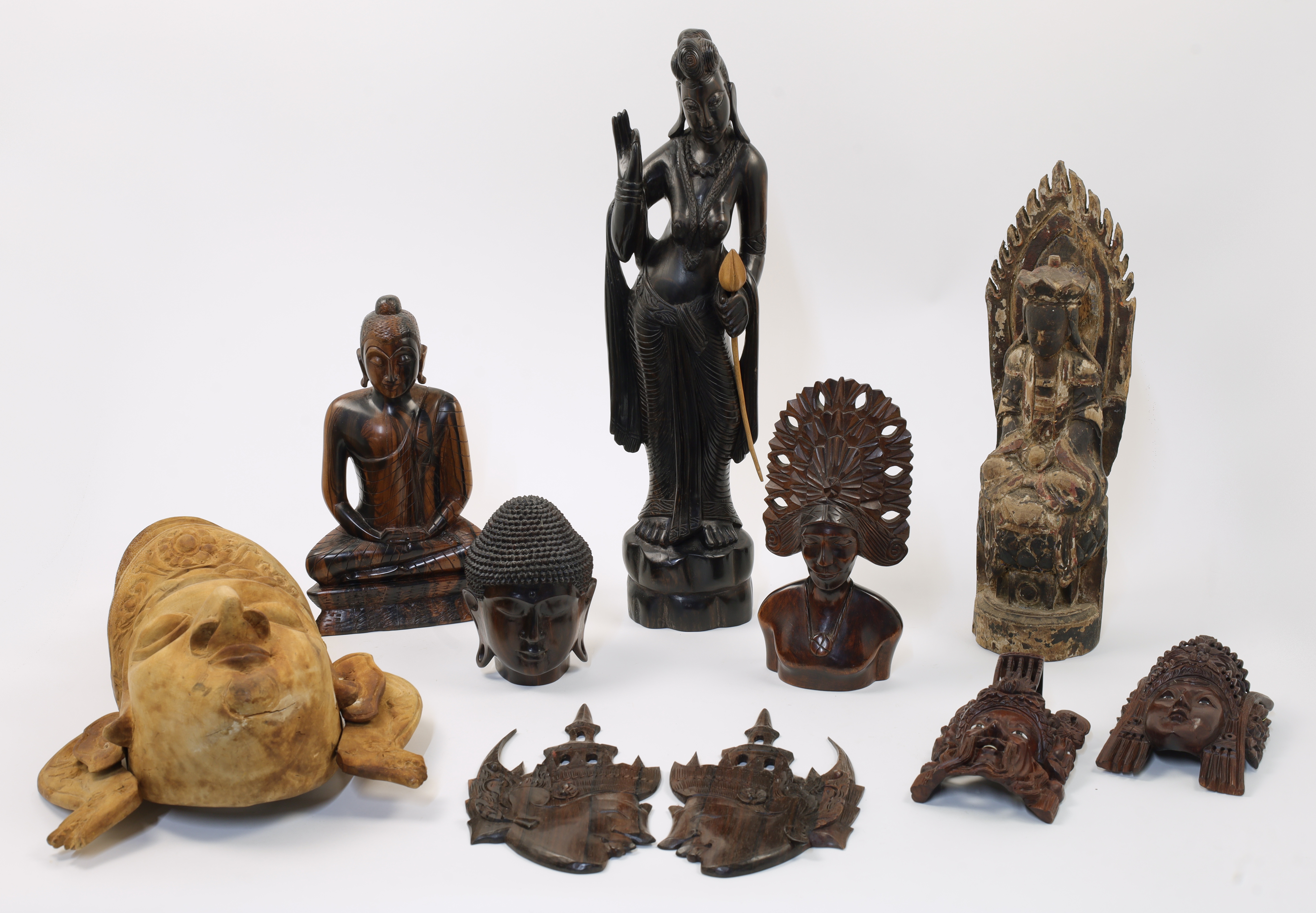 A mixed group of carved wood Asian and South East Asian tourist wares, 20th century, to include a...