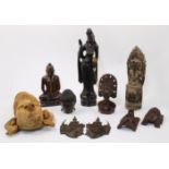 A mixed group of carved wood Asian and South East Asian tourist wares, 20th century, to include a...