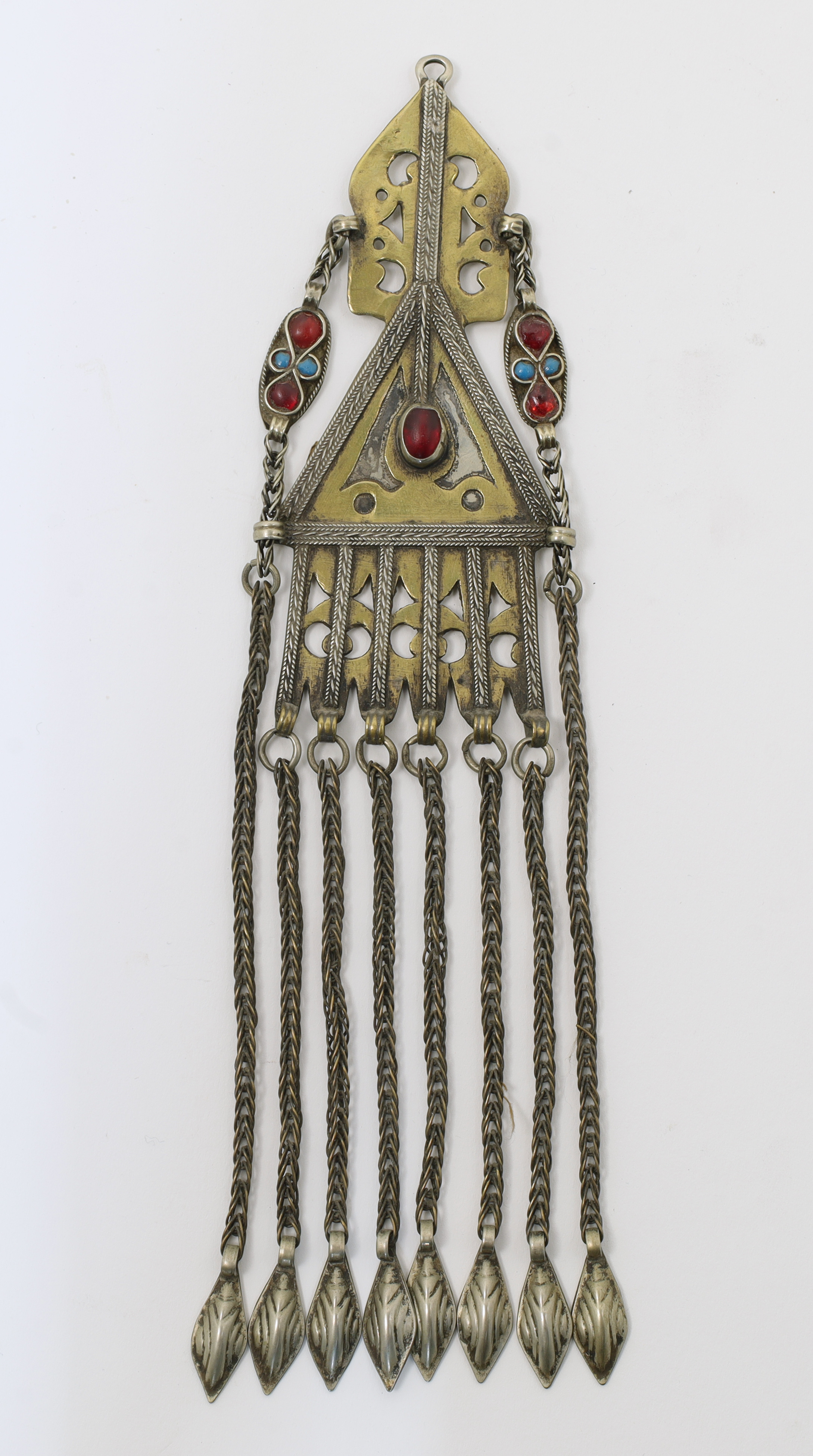 A brass temple pendant, Turkmenistan, 19th century, inset with red and turquoise hardstones, with...