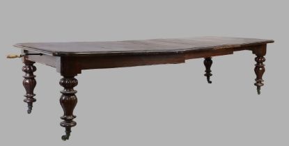 A Victorian mahogany wind out dining table, third quarter 19th century, on carved baluster legs a...