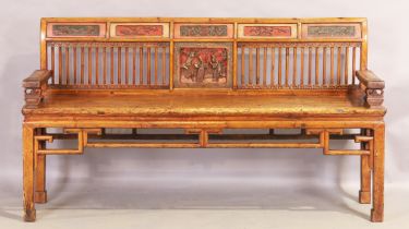 A Chinese hardwood bench, first quarter 20th century, the stick back with carved panels and part ...