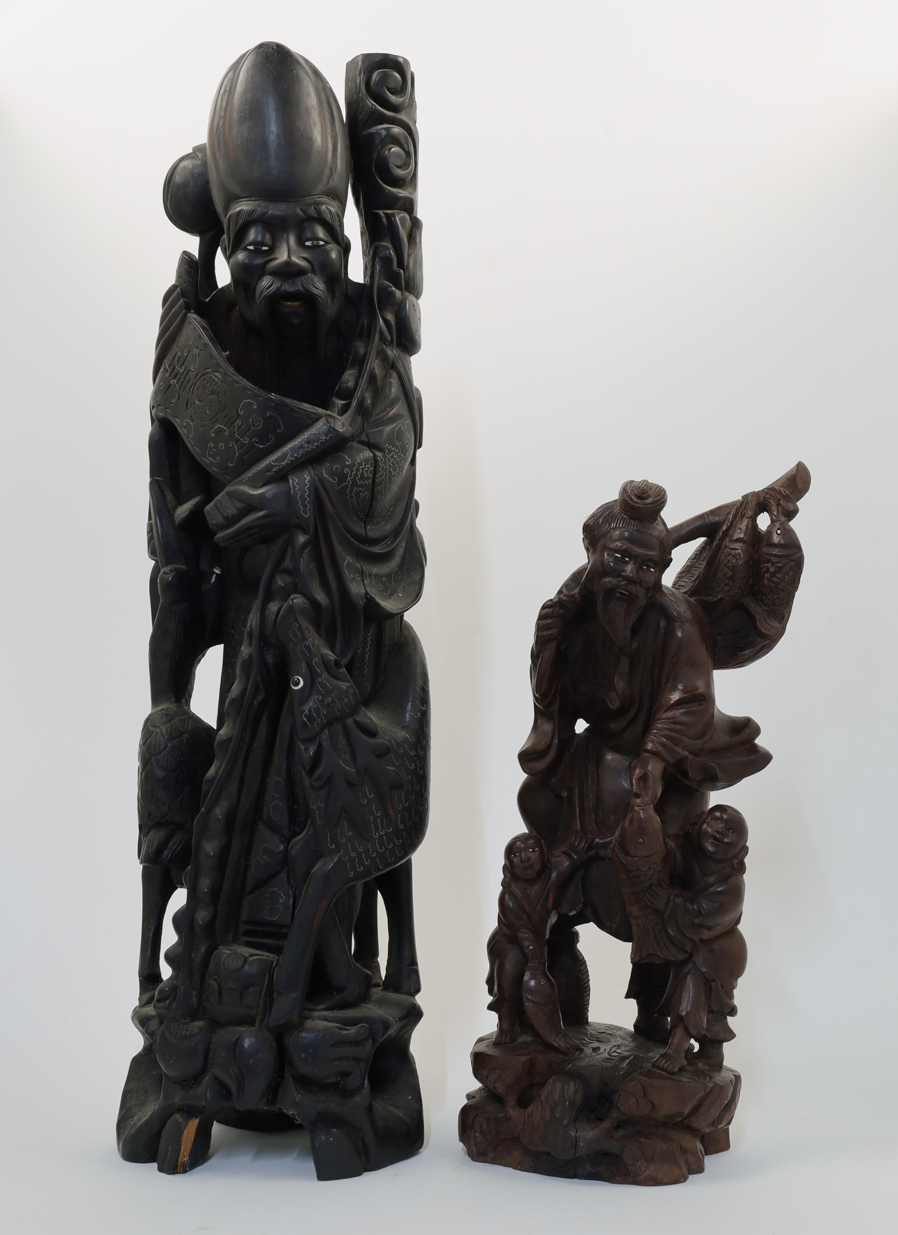 Two Chinese carved hardwood figures, 20th century, the first depicting Shoulao with inset eyes, w...