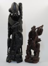 Two Chinese carved hardwood figures, 20th century, the first depicting Shoulao with inset eyes, w...