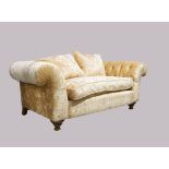 A modern John Sankey chesterfield sofa, with beige chenille velour upholstery, on turned front fe...