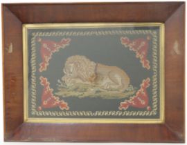 A pair of British needlepoint pictures of lions, early 19th century, each held in glazed rosewood...