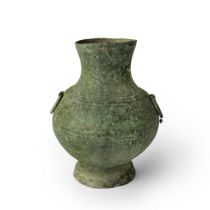 A Chinese archaic bronze vessel, hu, Han dynasty, the rounded body cast with ribbed bands raised ...