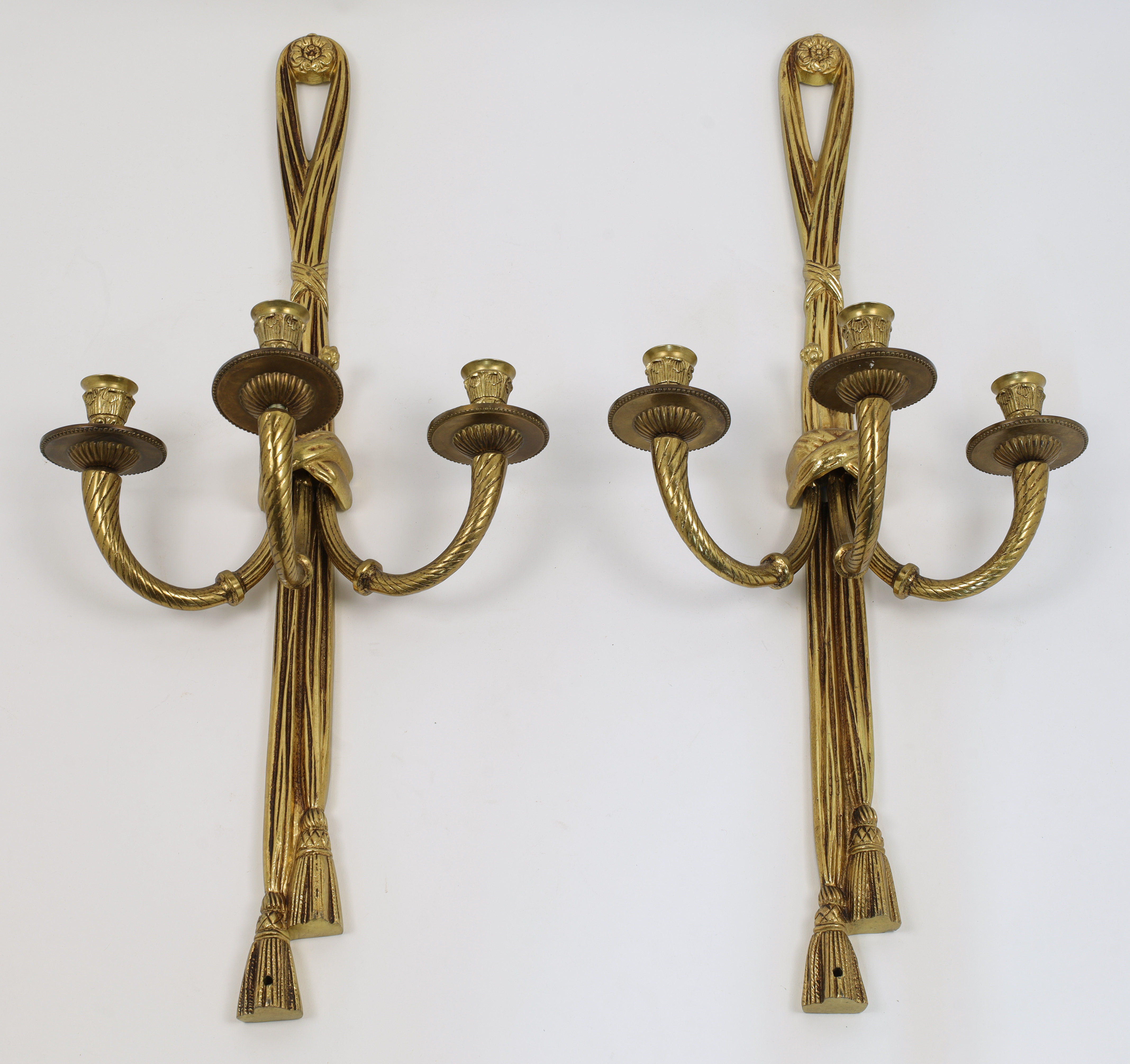 A pair of gilt-bronze three light wall appliques, second half 20th century, each with ribbon-tied...