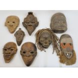 A group of West African and other tribal tourist ware masks, late 20th / 21st century, comprising...