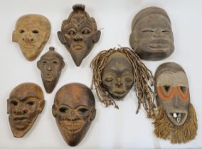 A group of West African and other tribal tourist ware masks, late 20th / 21st century, comprising...